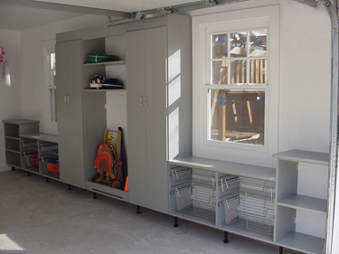 Cabinets and shelves extend closet space - even in a garage.