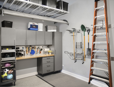 Cabinets and wall racks aid garage organization.